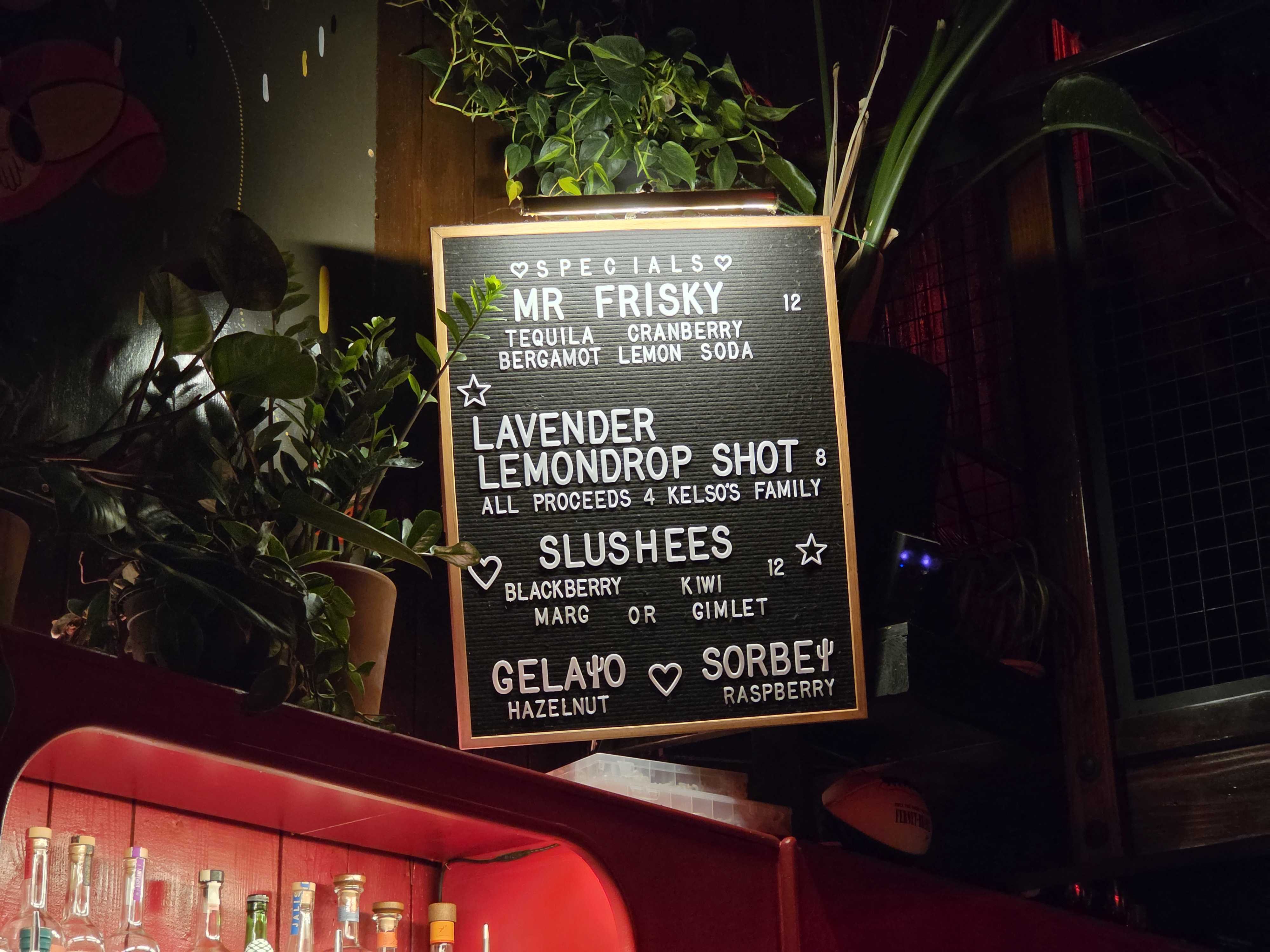 A bar menu in a dark room (3x)