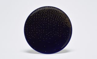 A black plate with the gold star sprinkle line design.