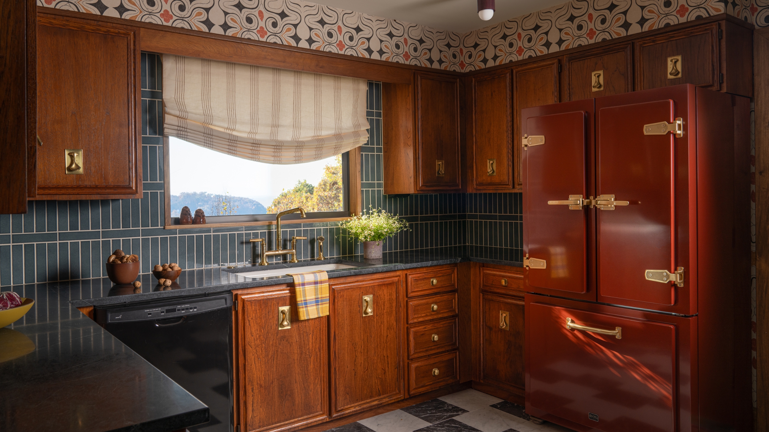 A mid-century kitchen with original wooden cabinets, a blue tile backsplash and Japanese-inspired wallpaper