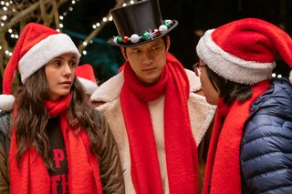 Nina Dobrev wears a santa hat in 'Love Hard'