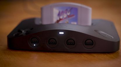 Analogue 3D console on wood surface with 1080 Snowboarding cartridge inserted.