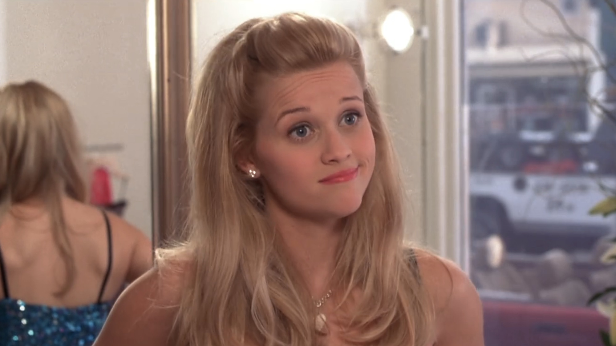 Elle smiling while shopping in Legally Blonde.