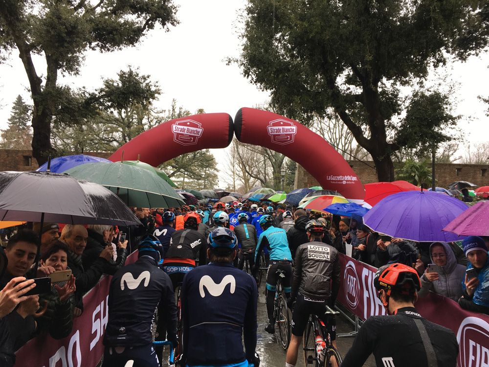 Riders line up for the start in the pouring rain