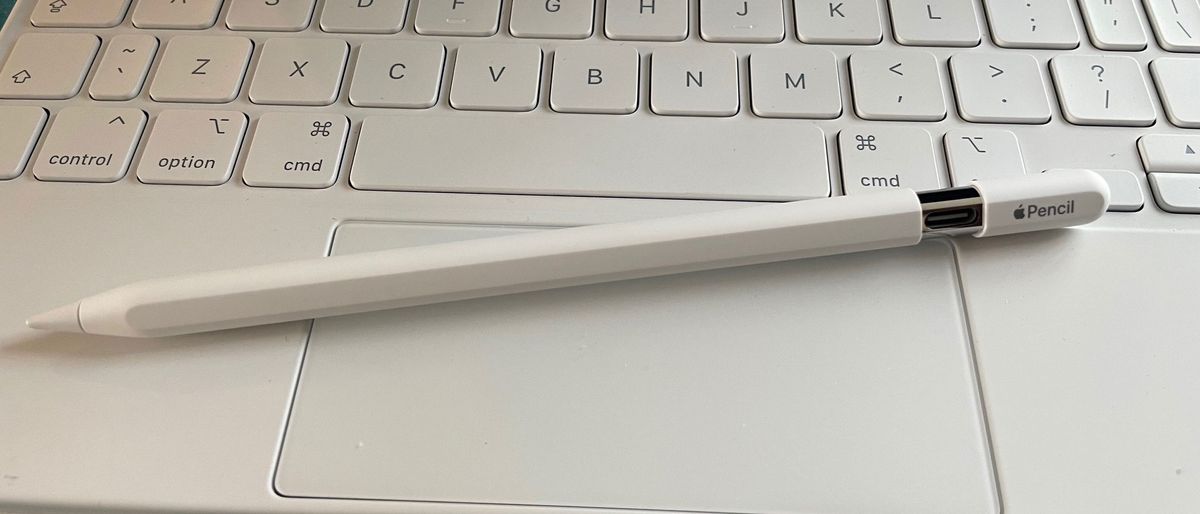 Apple Pencil USB-C on a white Magic Keyboard