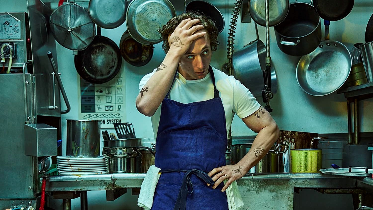 Jeremy Allen White puts his hand to his head in the kitchen in The Bear