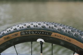 A tan gravel tyre against a river backdrop