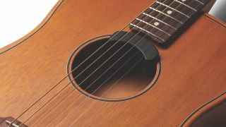 A close up around the soundhole of a Fender Highway Dreadnaught electro acoustic guitar
