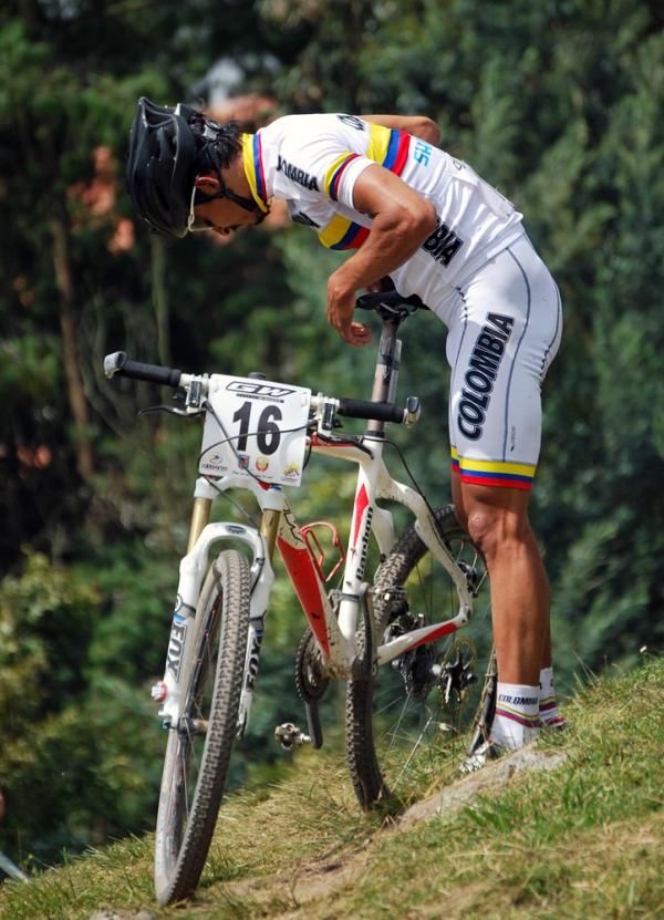 Luis Anderson Mejia Sanchez (Colombia) checks out a mechanical issue