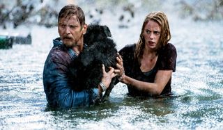 Crawl Barry Pepper and Kaya Scodelario carry a dog through a flooded street