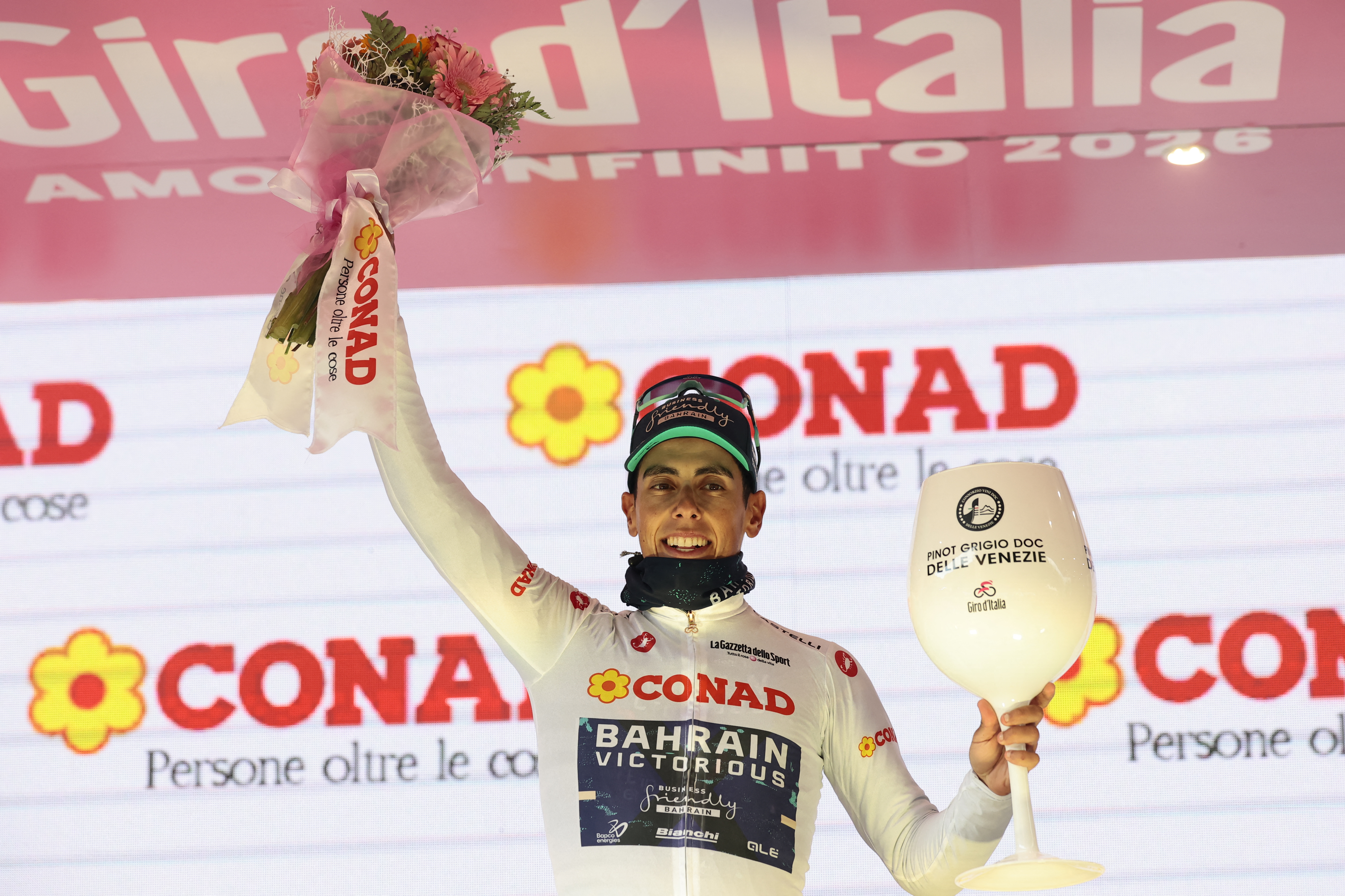 Bahrain - Victorious Portuguese rider Afonso Eulalio, wearing the best young rider's white jersey (Maglia Bianca), celebrates on the podium for the 9th stage of the Giro d'Italia 2026 - Tour of Italy cycling race between Cervia and Corno alle Scale, near Doganaccia, central Italy on May 17, 2026. (Photo by Luca Bettini / AFP)