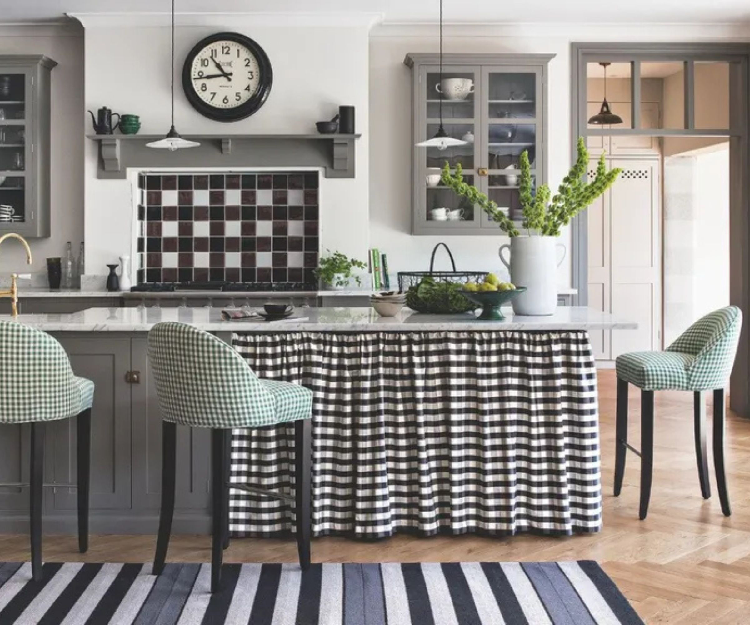 A transitional kitchen with a skirted kitchen island