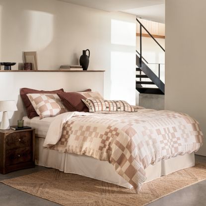 expensive looking bedding from M&S in neutral colours in a bedroom