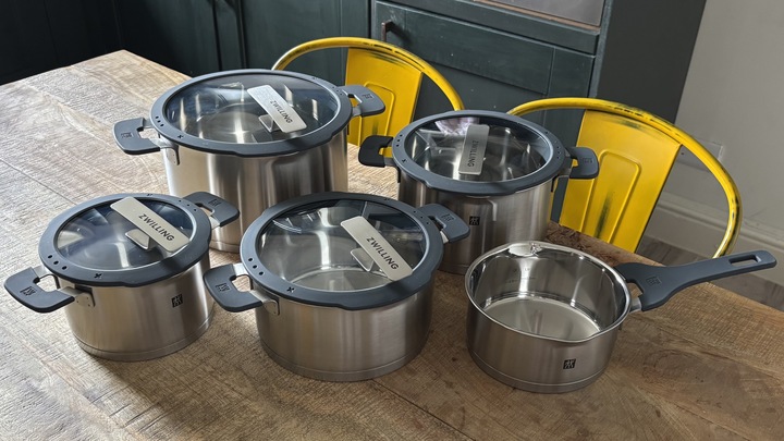 The Zwilling Simplify Pot Set posed on a wooden kitchen table.