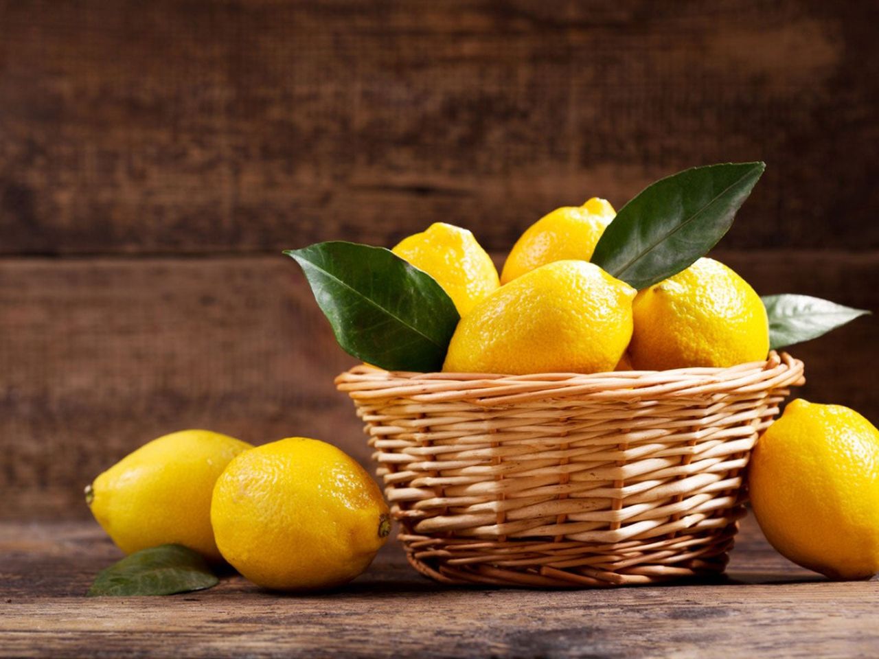 Wooden Basket On Table Full Of Lemons