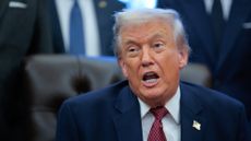 President Donald Trump speaks to reporters in the Oval Office.