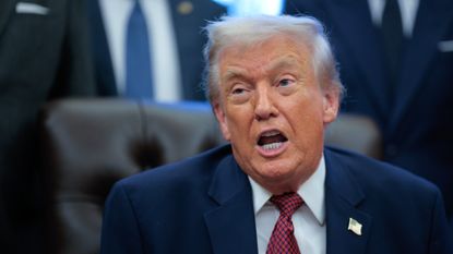 President Donald Trump speaks to reporters in the Oval Office.