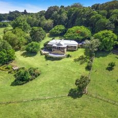 house with grassland and trees