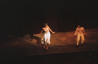 Princess Diana dancing on stage with Wayne Sleep in 1985 wearing a white slip dress