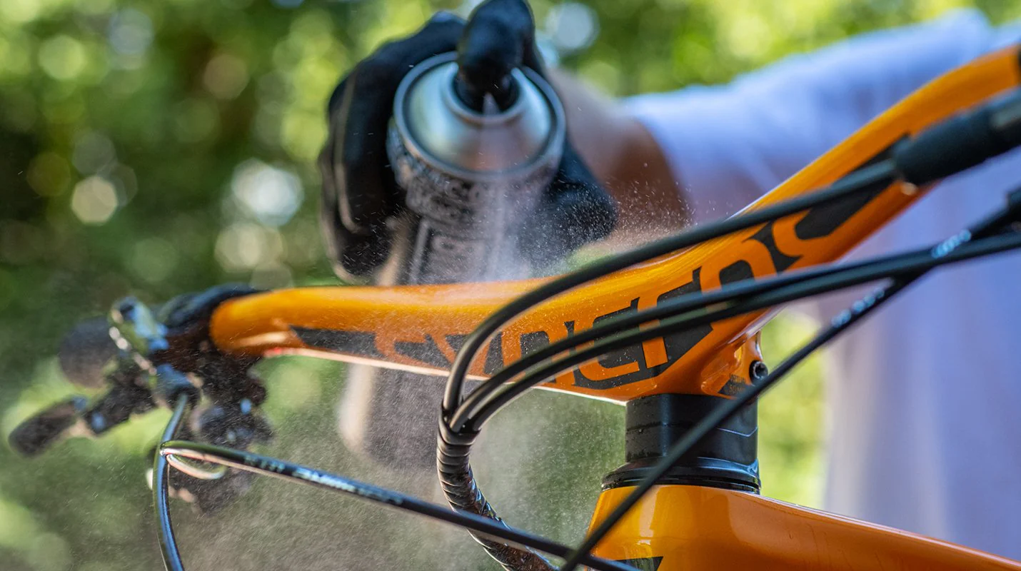 Muc-Off Spray Protect applied to bike handlebars outside