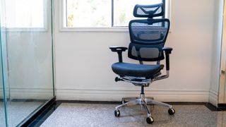 A black mesh OdinLake Ergo PLUS 743 office chair in an office hallway