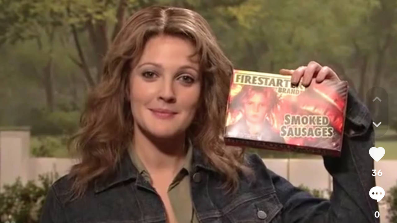 Drew Barrymore as Firestarter holding a box of smoked sausages on SNL
