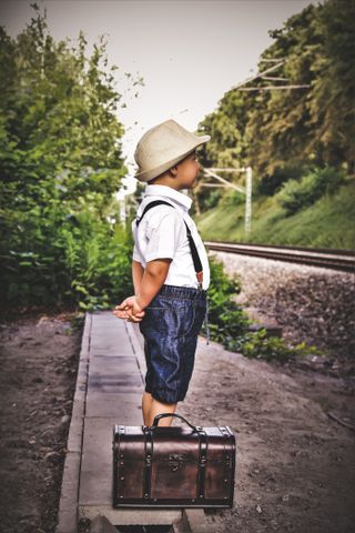 A young traveller waits patiently at the platform in Soest, Germany, for his train to take him on an adventure