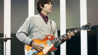 Keith Richards of rock group The Rolling Stones plays a Gibson Les Paul guitar with Bigsby Vibrato on the set of the ABC Television pop music television show Thank Your Lucky Stars at Alpha Television Studios in Birmingham, England on 21st March 1965