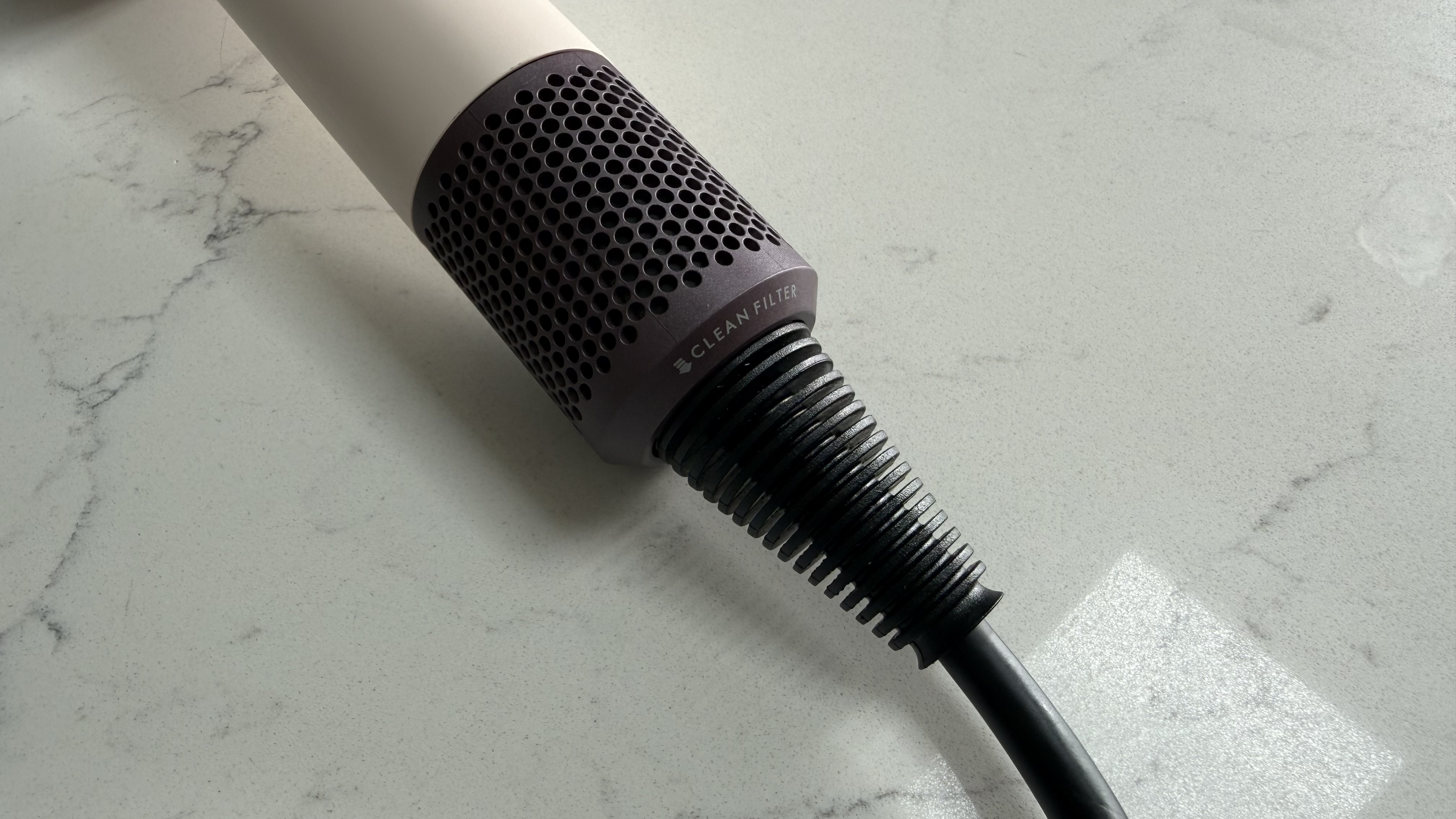 Dyson Supersonic Travel hair dryer filter and power cord connection at the base of the handle