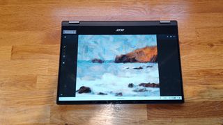 Acer Chromebook Spin 514 review; an laptop in tablet mode on a wooden bench