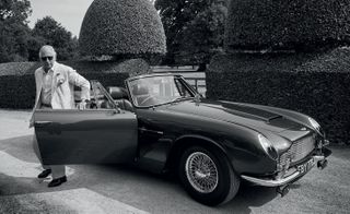 Prince Charles steps from his 1969 Aston Martin DB6 MKII Volante in the grounds of the Highgrove Estate in Gloucestershire