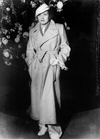 The German Actress Marlene Dietrich Wearing Mens trousers and a trenchcoat In Paris In 1933.