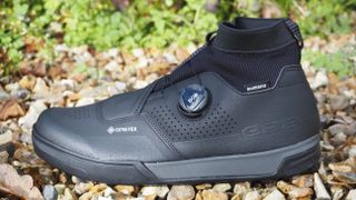 A single Shimano flat pedal winter boot viewed side on