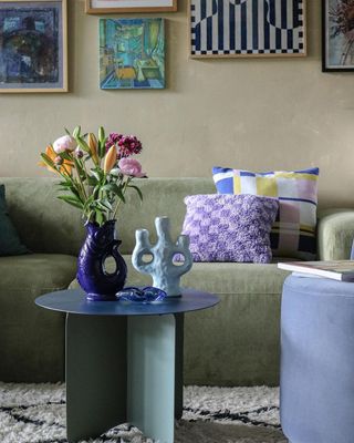 Green couch with purple cushions
