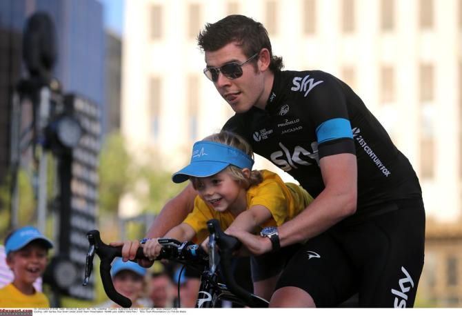 Luke Rowe gives one young fan a go on his Pinarello bike