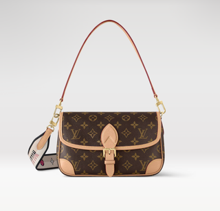 a monogram Louis Vuitton Diane bag in front of a plain backdrop