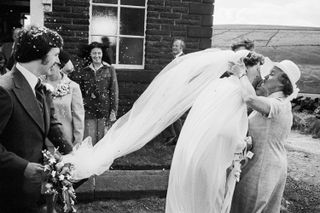 Bride and groom being showered with confetti