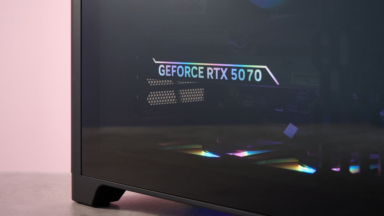 Close-up of Nvidia GeForce RTX 5070 GPU inside the Lenovo Legion Tower 5, on a desk with pink wall in background