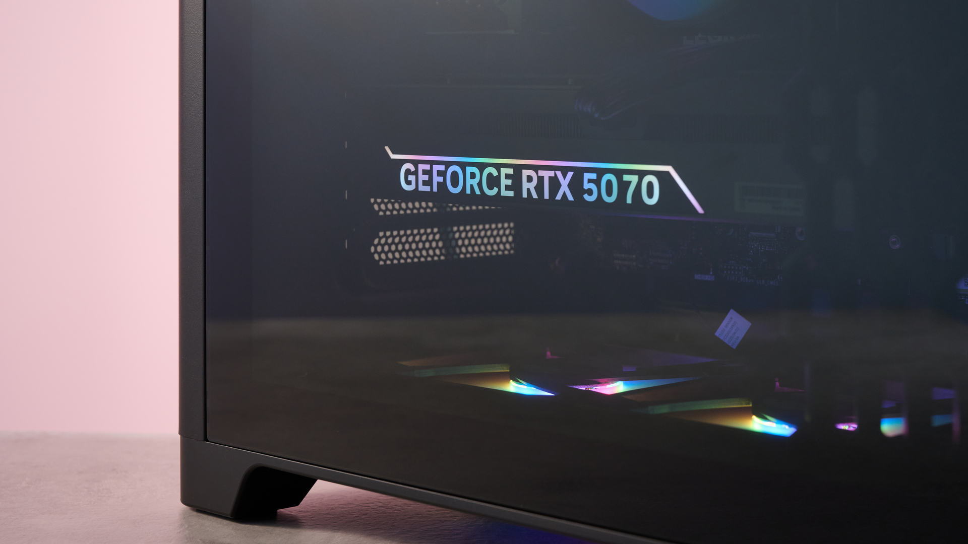 Close-up of Nvidia GeForce RTX 5070 GPU inside the Lenovo Legion Tower 5, on a desk with pink wall in background
