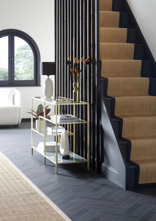 black wooden staircase with long spandrels in hallway