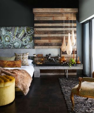 An example of bohemian bedroom ideas showing a bedroom with rustic textures, faux fur throws and a trio of lamps