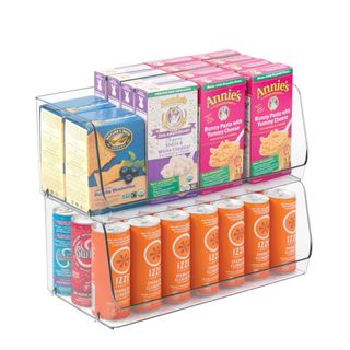 Two clear stacked organizer bins with colorful boxes and cans in them