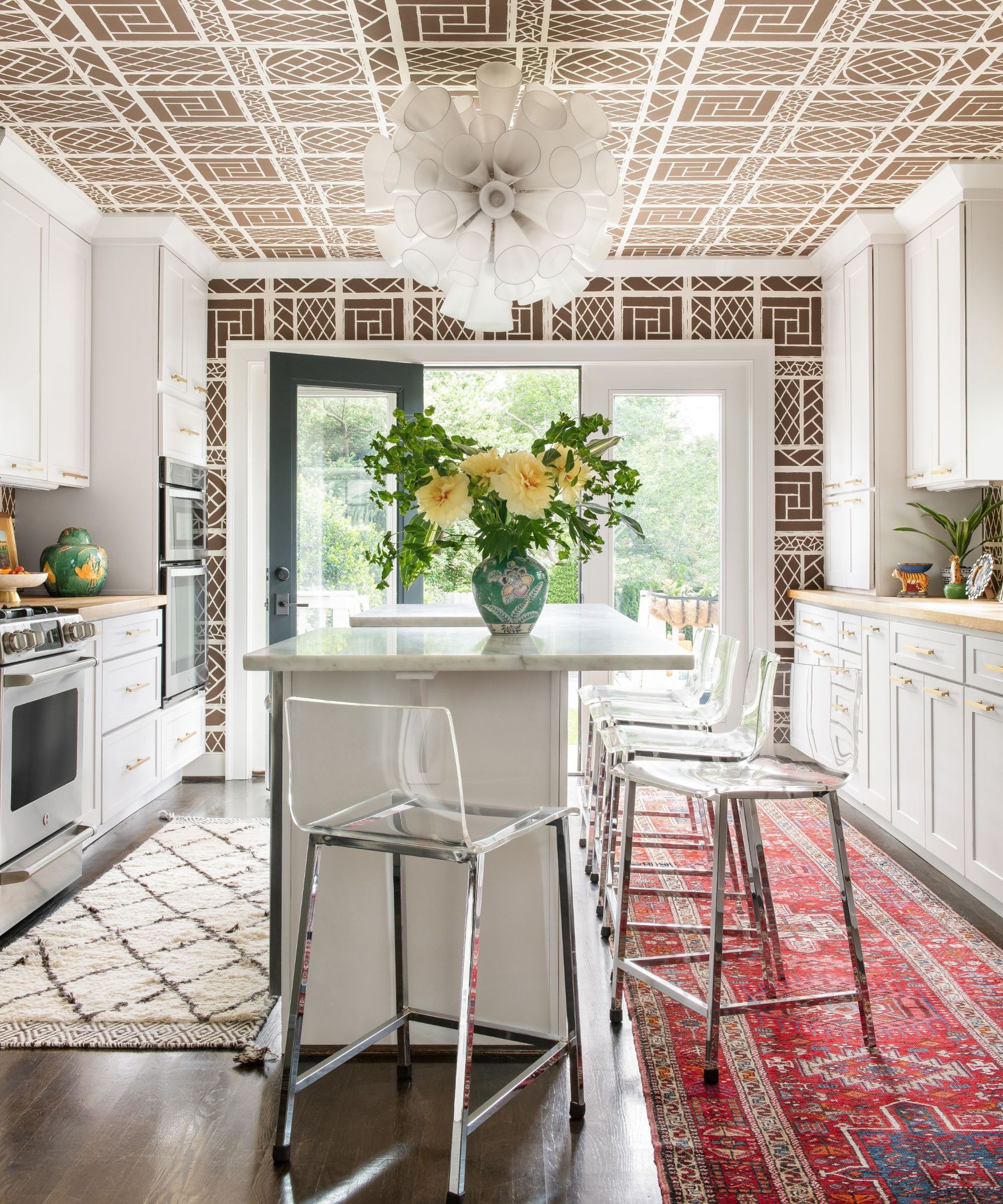 Red and white rugs, transparent chairs, white cupboards
