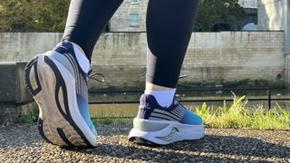 Woman's feet wearing Saucony Endorphin Shift 3 road running shoes - rear view