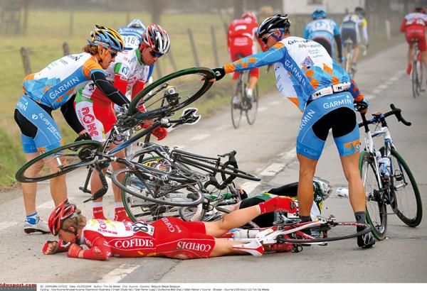 Tyler Farrar and Kilian Patour untangle a bike while Guillaume Blot remains on the ground