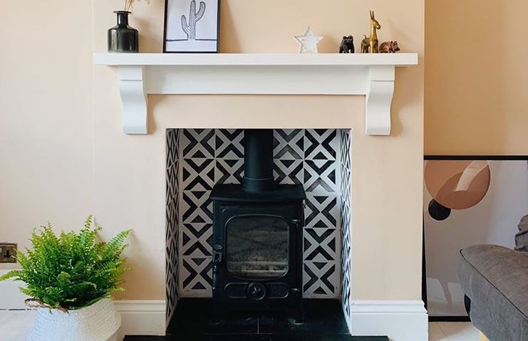 Tiled black and white fireplace hearth in neutral lounge