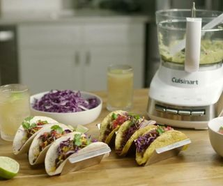 Cuisinart Core Food Processor on a kitchen counter, surrounded by tacos.