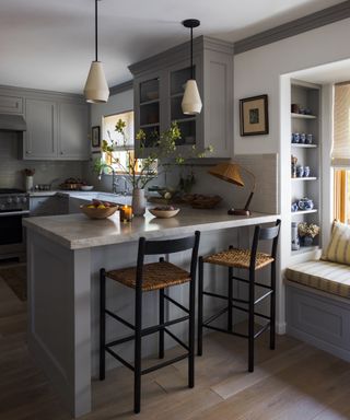 small grey kitchen with banquette dining nook