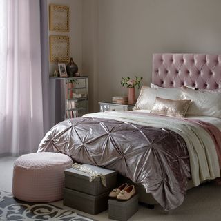 bedroom with headboard and pink flower vase