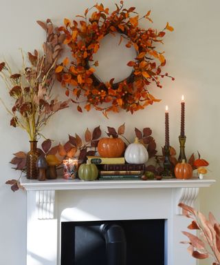 Mantelpiece styled with a fall wreath, garland and pumpkin ornaments