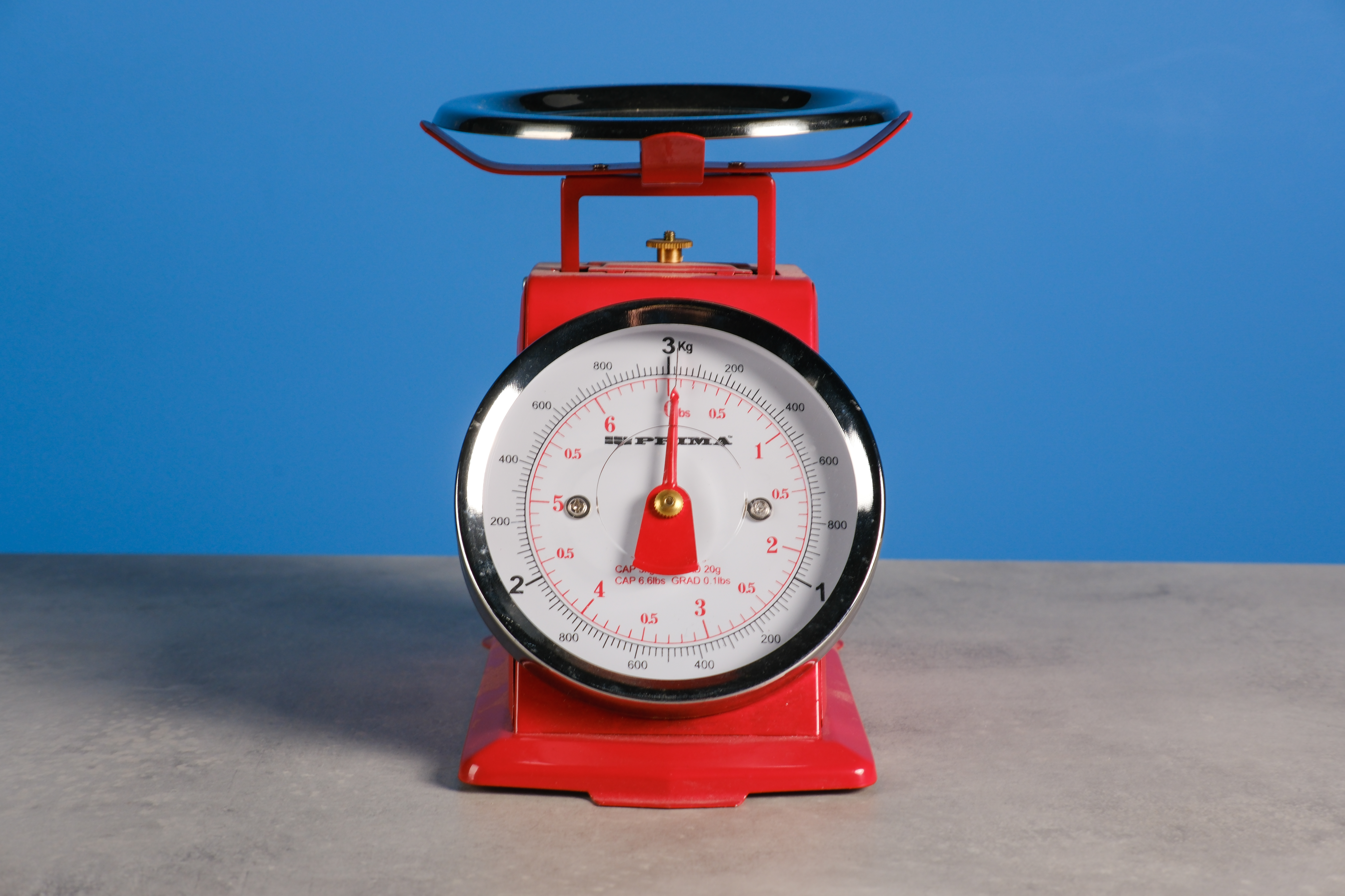 A red set of scales against a blue background